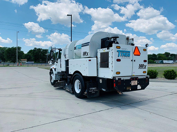 2006 TYMCO 500X Sweeper (#004146): Mounted on an International 4200 Chassis. Two Gutter Brooms - Drop Down and Hi/Low Pressure Wash Down. Act Now On This One! Driver side rear 3/4 view.