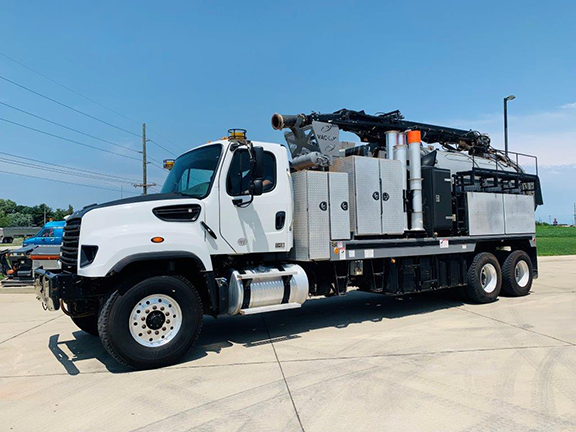 2015 Vac-Con Hydroexcavator (#006953), Mounted on a Freightliner 114SD 6x4 66000GVWR ISL370 3000RDS. A 20 gpm / 4000psi Water System, hydraulically driven. 8’ x 8” Rear Mounted Telescoping Power Flex Boom with Pendant Control Station. Includes 12-yard Debris Tank and PD Blower. Driver side front 3/4 view.